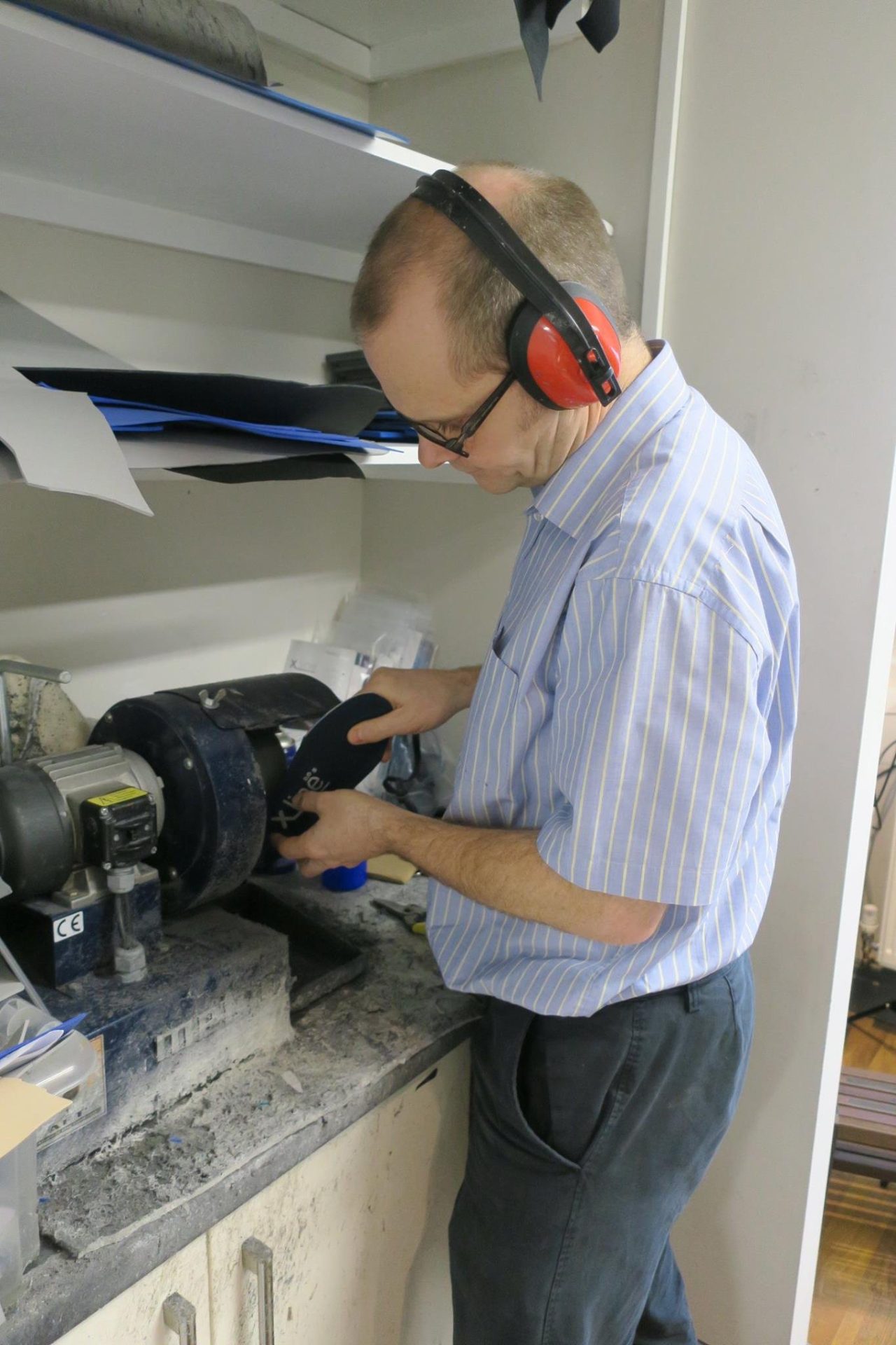 Foot orthoses being prepared during a podiatry assessment.